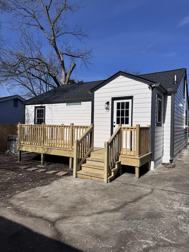 rear view of house with a patio and a wooden deck