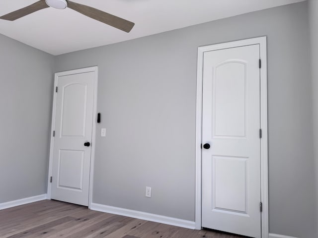 unfurnished bedroom featuring ceiling fan and wood-type flooring