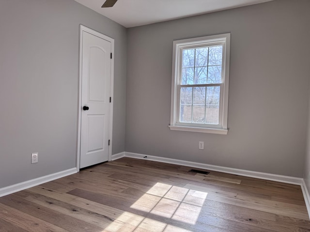 empty room featuring ceiling fan and light hardwood / wood-style flooring