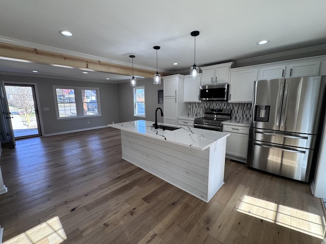 kitchen featuring white cabinetry, sink, a center island with sink, and appliances with stainless steel finishes