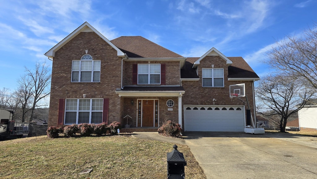 front of property with a garage and a front lawn