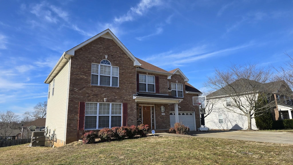 front facade featuring a garage and a front yard