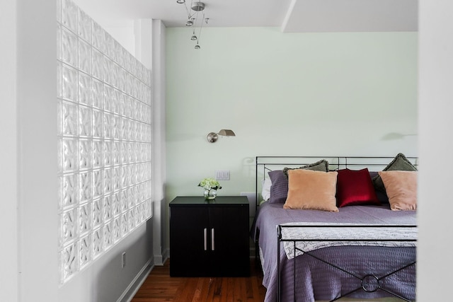 bedroom with dark hardwood / wood-style floors