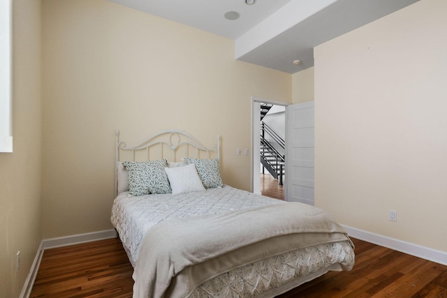 bedroom with dark hardwood / wood-style flooring