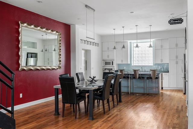 dining room featuring sink and dark hardwood / wood-style floors