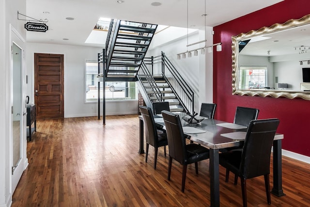 dining area with a healthy amount of sunlight and dark hardwood / wood-style floors