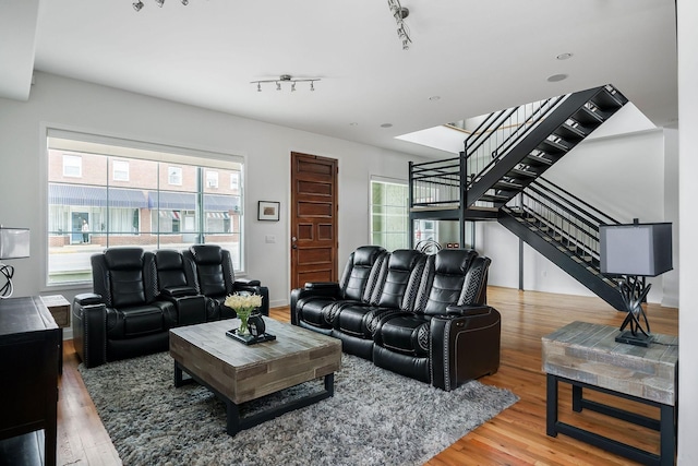 living room featuring rail lighting and hardwood / wood-style floors