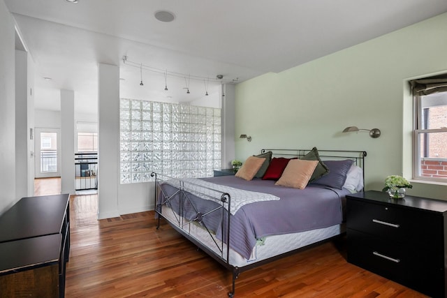 bedroom with dark hardwood / wood-style flooring