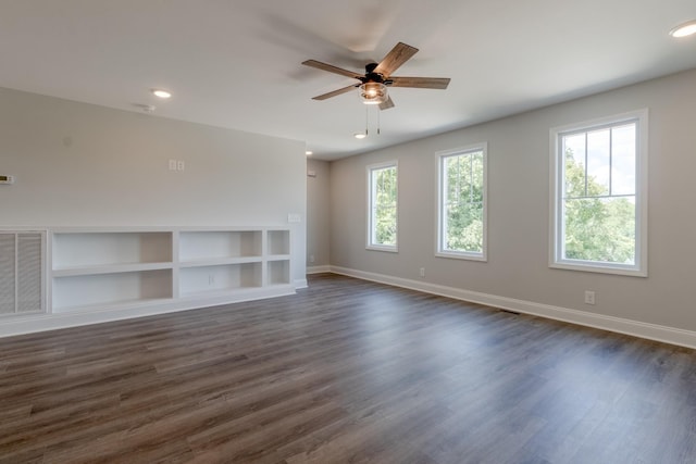 interior space with dark hardwood / wood-style flooring and a wealth of natural light