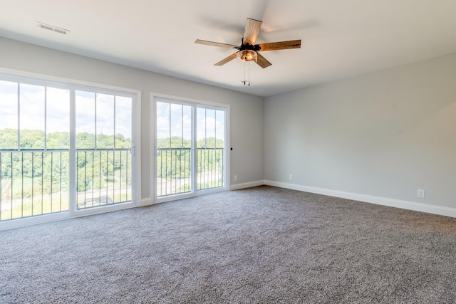 unfurnished room featuring ceiling fan and carpet