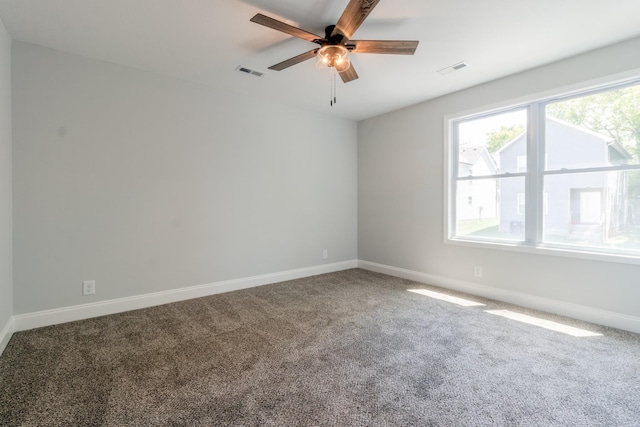 spare room featuring ceiling fan and carpet