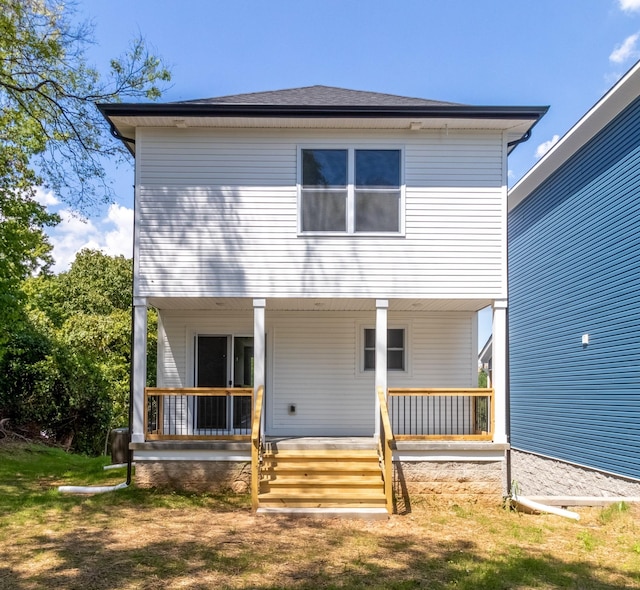 rear view of house featuring covered porch