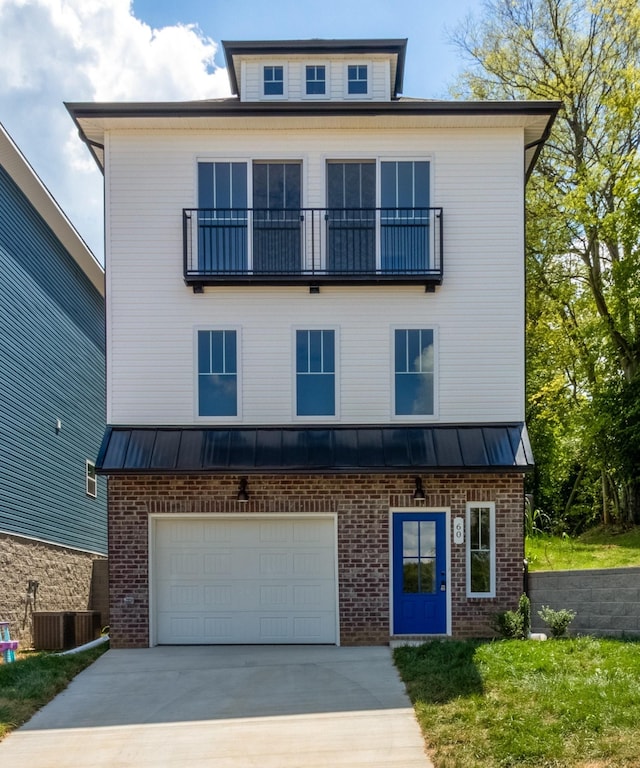 view of front of property featuring a garage and central AC