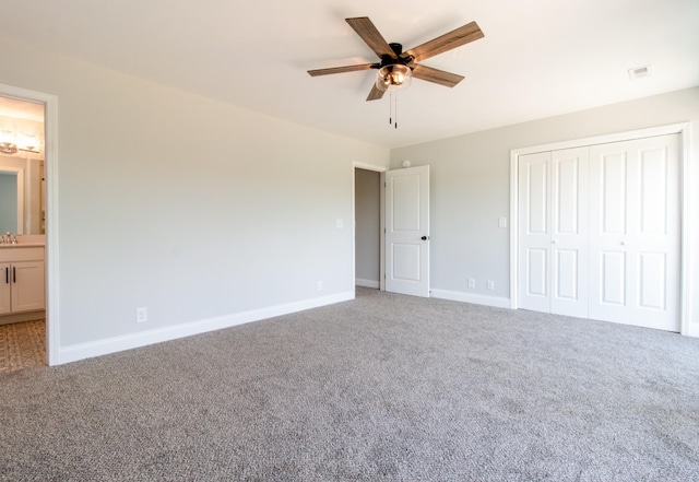 unfurnished bedroom featuring ceiling fan, connected bathroom, carpet floors, and a closet