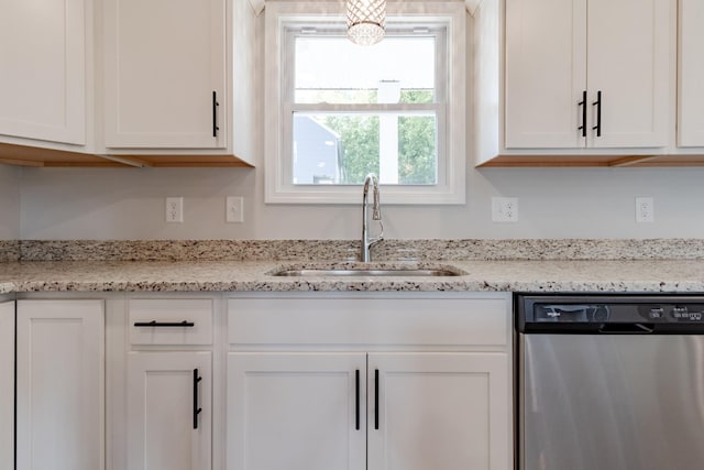 kitchen featuring white cabinetry, stainless steel dishwasher, light stone countertops, and sink