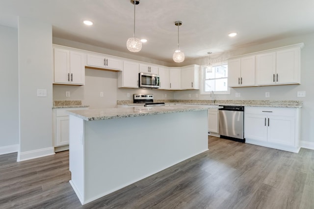 kitchen featuring appliances with stainless steel finishes, a center island, and white cabinets