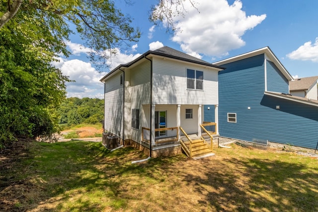 rear view of property with a lawn and covered porch