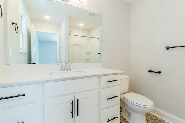 bathroom featuring walk in shower, vanity, and toilet