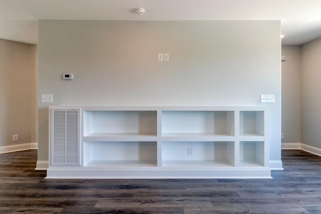 interior details featuring hardwood / wood-style flooring and built in shelves