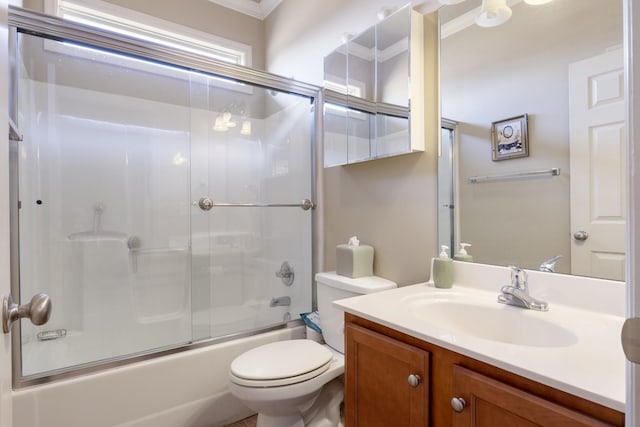 full bathroom featuring vanity, bath / shower combo with glass door, and toilet