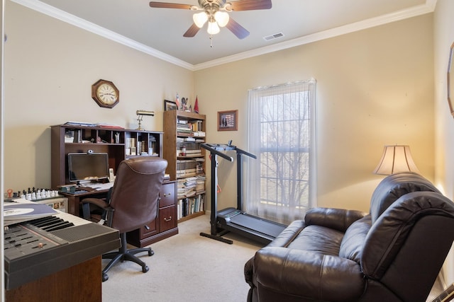 carpeted home office featuring crown molding and ceiling fan