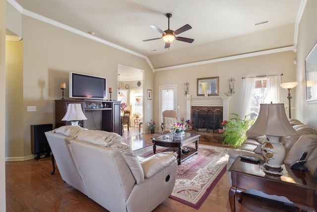 living room featuring ornamental molding, lofted ceiling, hardwood / wood-style floors, and ceiling fan