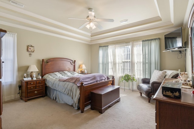 bedroom featuring a raised ceiling, ornamental molding, light carpet, and ceiling fan