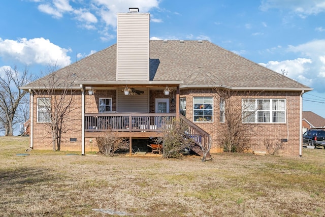 back of property with ceiling fan, a yard, and a deck