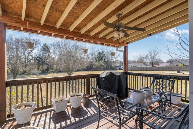 deck featuring area for grilling and ceiling fan