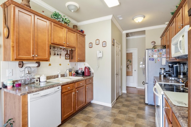 kitchen with sink, white appliances, ornamental molding, and backsplash