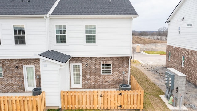 back of house featuring central AC