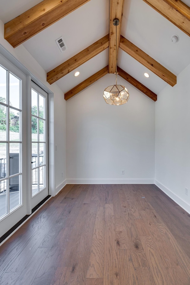 spare room with lofted ceiling with beams and dark hardwood / wood-style floors