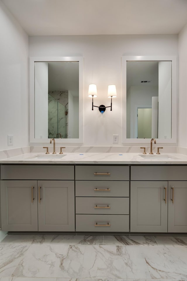 bathroom featuring a shower with door and vanity