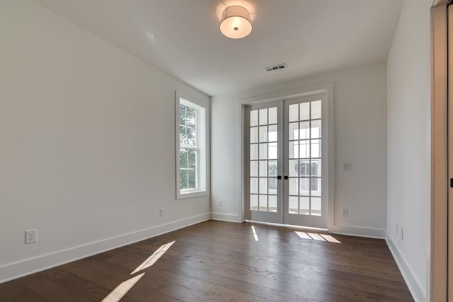 unfurnished room featuring dark hardwood / wood-style floors and french doors