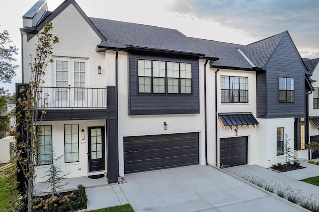 view of front of home with a garage and a balcony