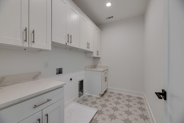 washroom with cabinets, hookup for a washing machine, and electric dryer hookup