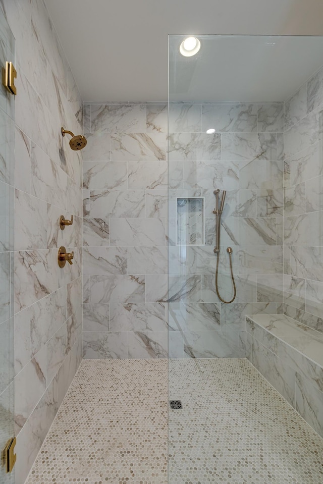 bathroom with a tile shower