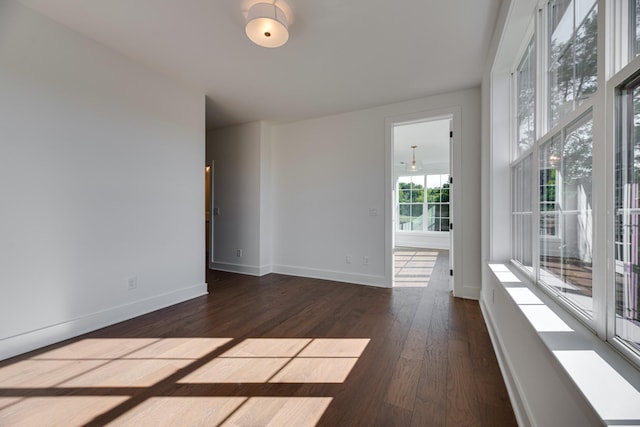 unfurnished room featuring dark hardwood / wood-style flooring