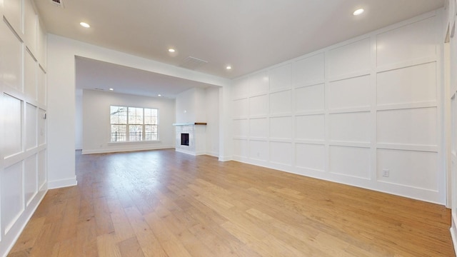 unfurnished living room with light hardwood / wood-style flooring