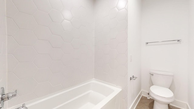 bathroom featuring tile patterned floors, toilet, and tiled shower / bath combo