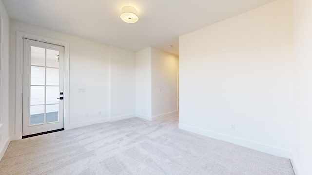 unfurnished room with light colored carpet