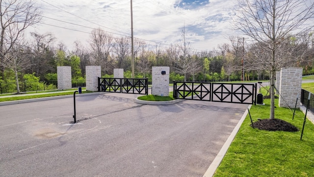 view of gate featuring a yard