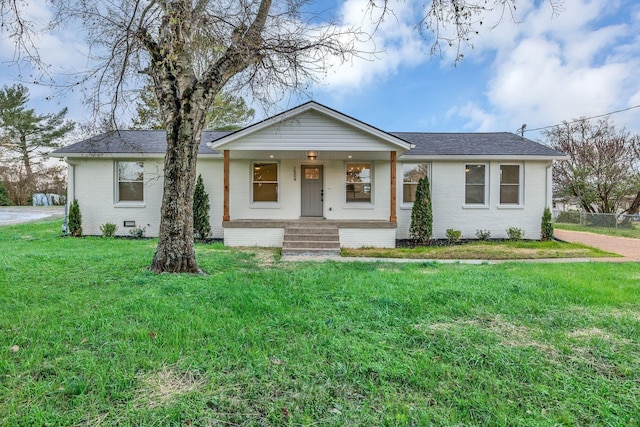 single story home with a front yard and covered porch