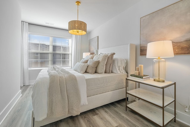 bedroom with wood-type flooring