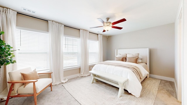 bedroom with ceiling fan and light carpet