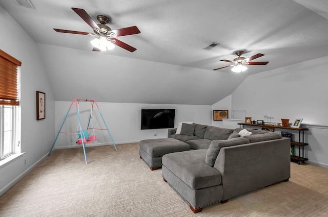 living area with lofted ceiling, light carpet, visible vents, and baseboards