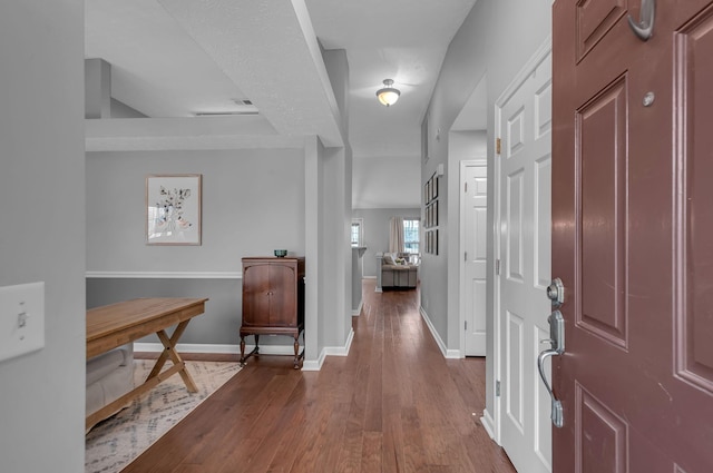 entryway with baseboards and wood finished floors