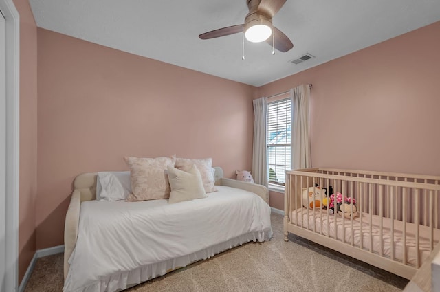 bedroom featuring a ceiling fan, carpet flooring, visible vents, and baseboards