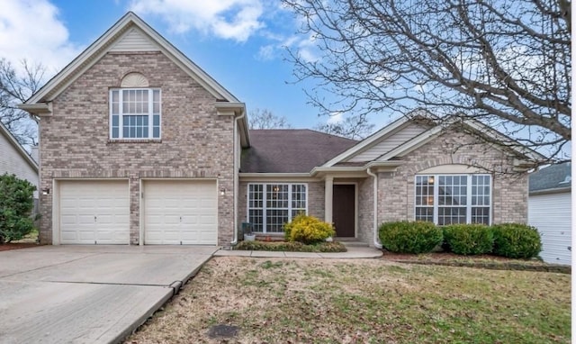 traditional home featuring concrete driveway and brick siding