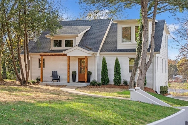 view of front of home with a porch and a front lawn